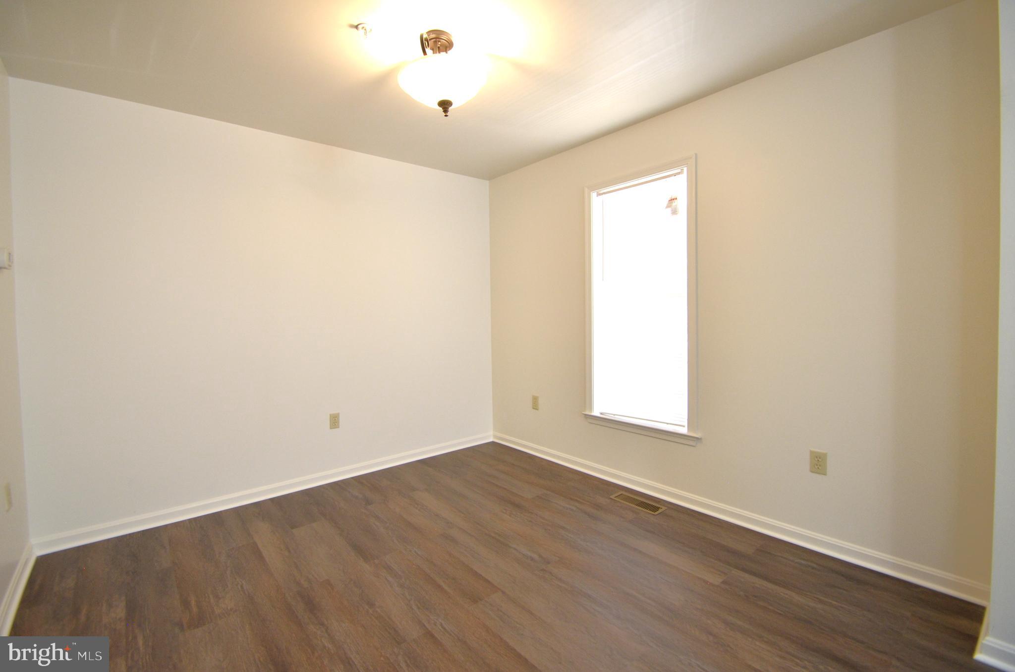 4 Ridge Road Southeast Washington, DC 20019 - Photo 32 of 47 an empty room with wooden floor and windows