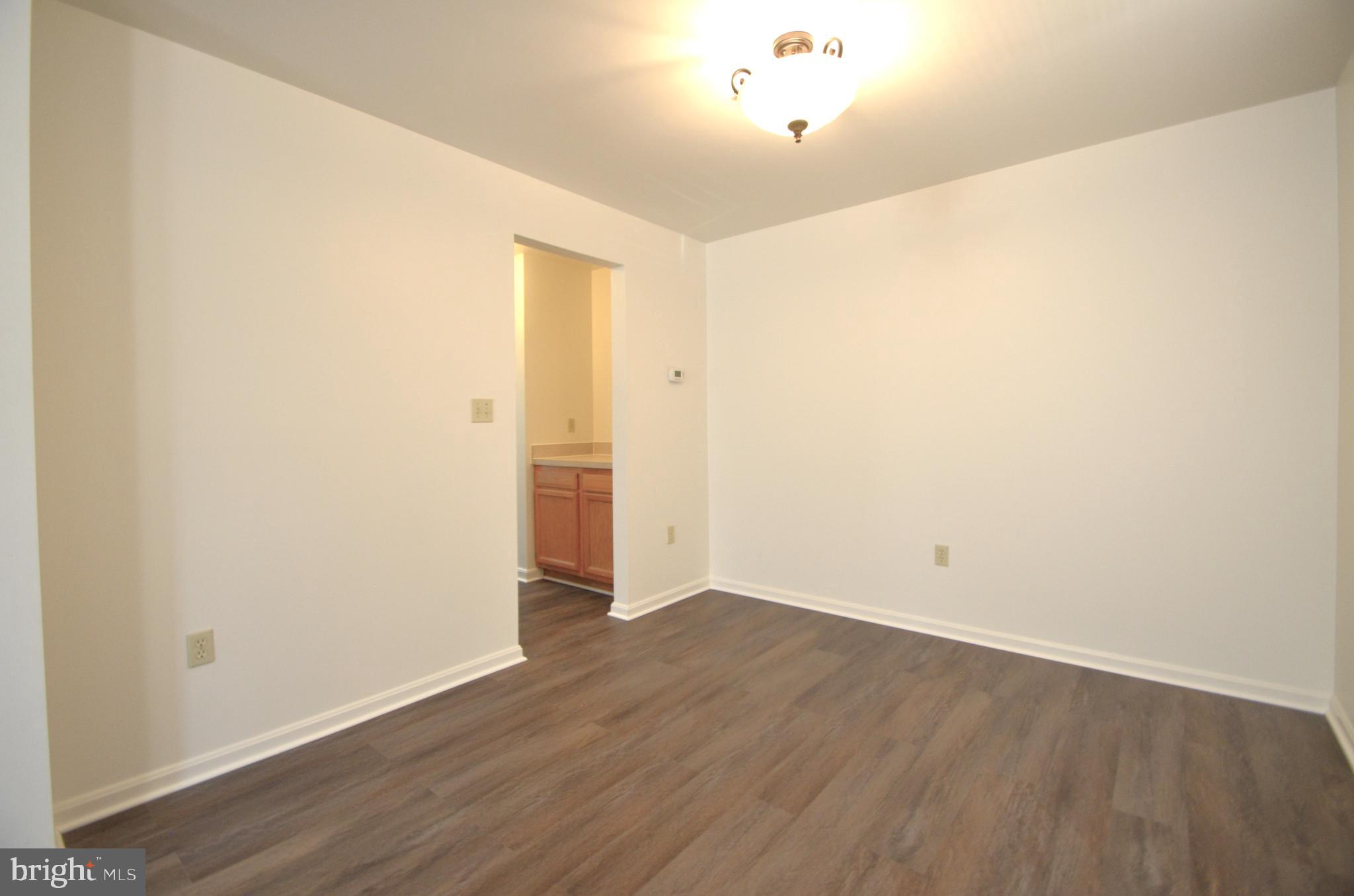 4 Ridge Road Southeast Washington, DC 20019 - Photo 41 of 47 an empty room with wooden floor and windows