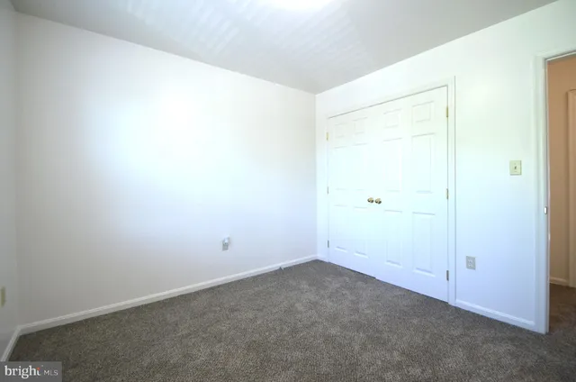 a backyard of a house with a bench