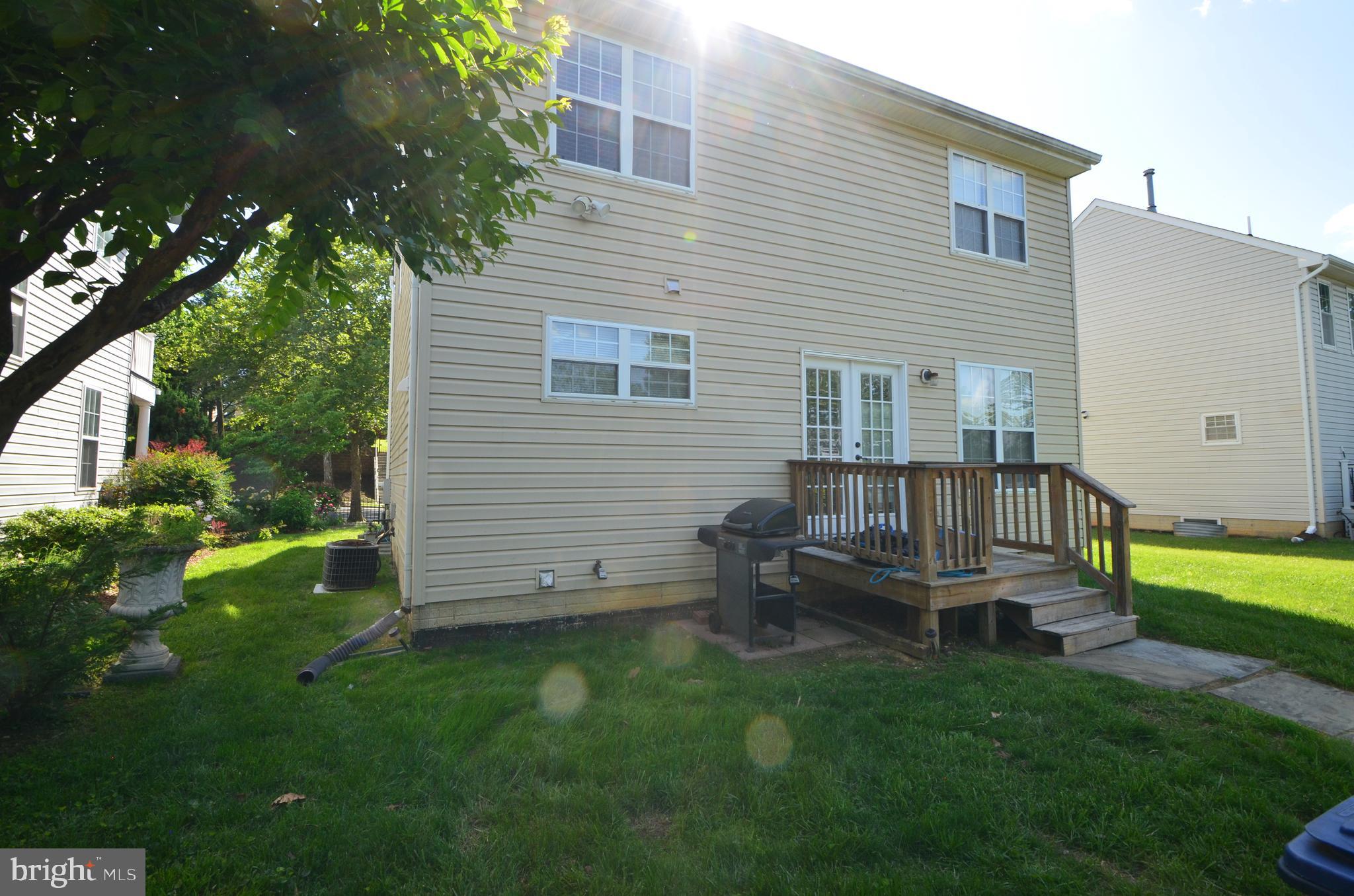 4 Ridge Road Southeast Washington, DC 20019 - Photo 47 of 47 a backyard of a house with table and chairs and a large tree