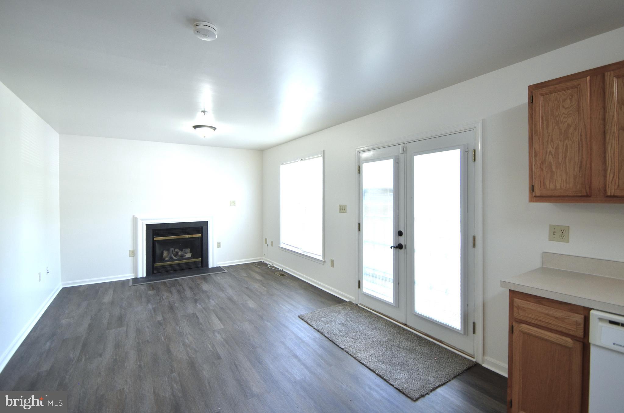 4 Ridge Road Southeast Washington, DC 20019 - Photo 5 of 47 an empty room with wooden floor and fireplace