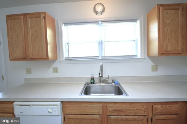 a kitchen with a sink cabinets and window