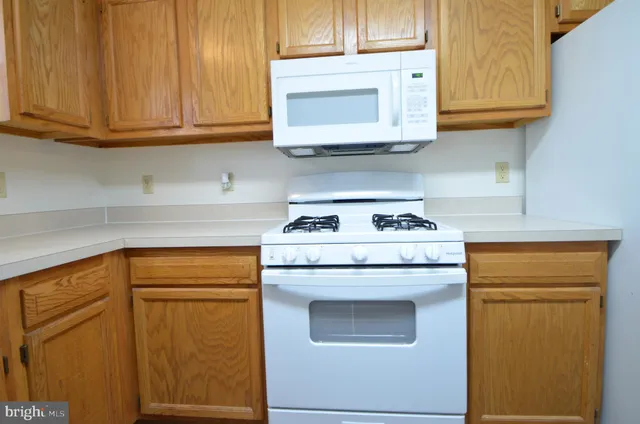 a kitchen with stainless steel appliances granite countertop cabinets and a refrigerator
