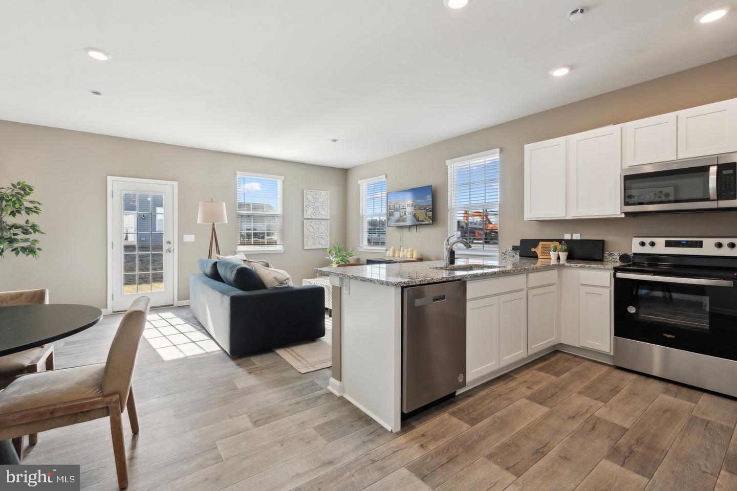 152 Rae Court Luray, VA 22835 - Photo 27 of 27 a kitchen with stainless steel appliances kitchen island granite countertop a stove top oven a sink a dining table and chairs