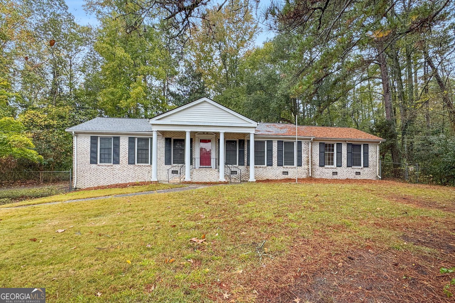 592 Hunnicutt Road Southeast Mableton, GA 30126 - Photo 1 of 1 a front view of a house with a garden