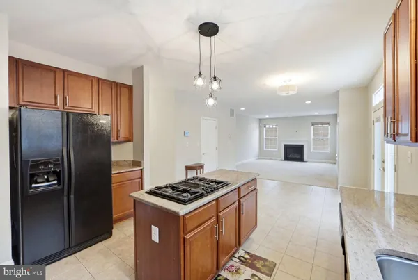 a large kitchen with stainless steel appliances granite countertop a stove a sink and a refrigerator