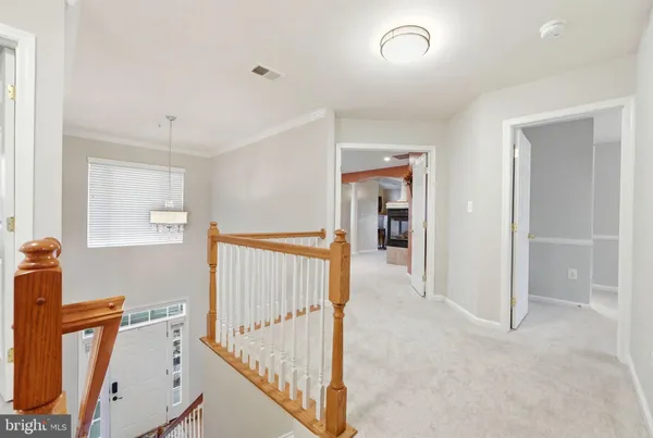 a view of an empty room with a fireplace and a window