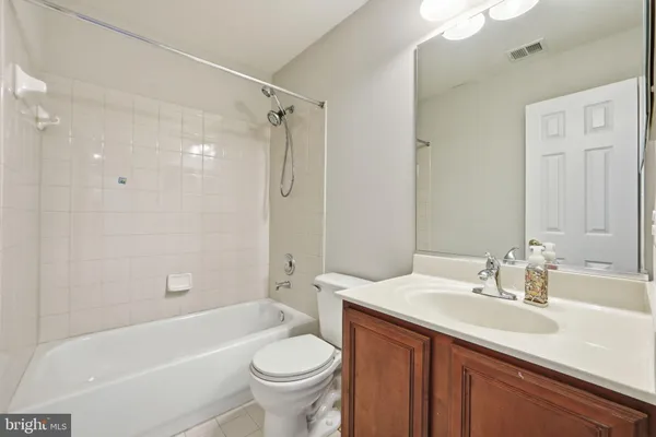 a bathroom with a sink double vanity granite tub and a mirror
