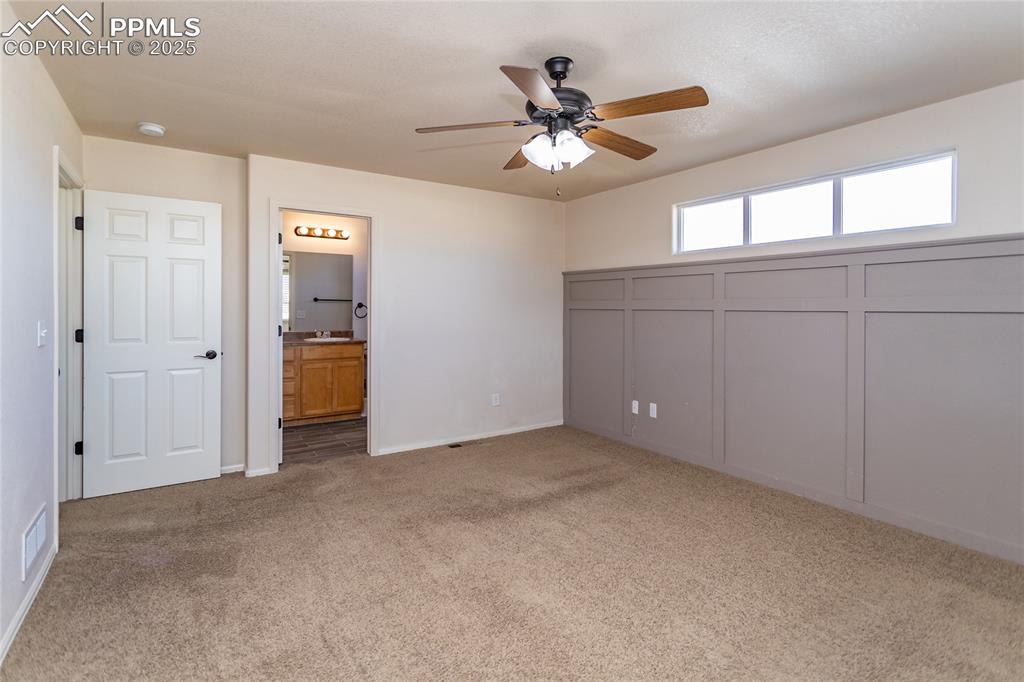 6806 Red Cardinal Loop Colorado Springs, CO 80908 - Photo 13 of 32 an empty room with closet and a chandelier fan