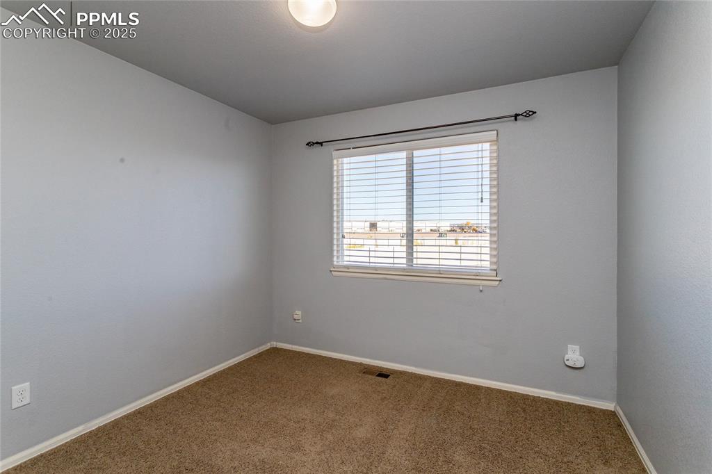6806 Red Cardinal Loop Colorado Springs, CO 80908 - Photo 14 of 32 an empty room with a window