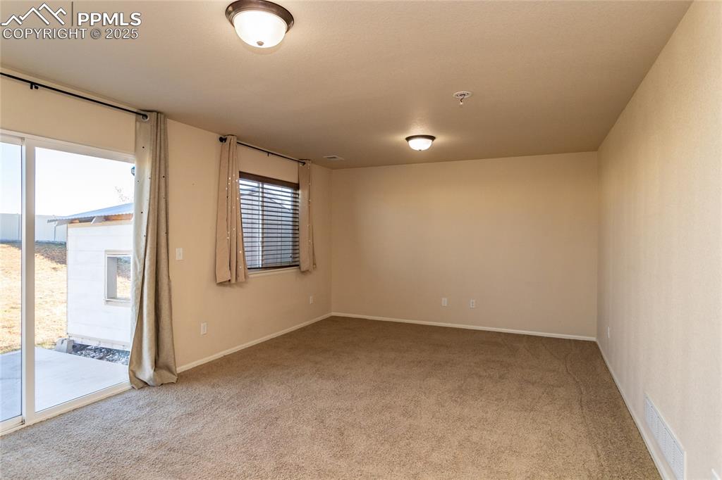 6806 Red Cardinal Loop Colorado Springs, CO 80908 - Photo 19 of 32 an empty room with windows