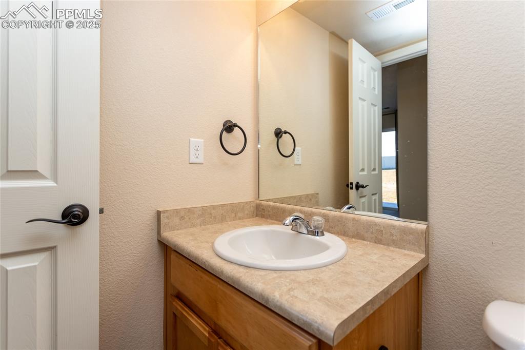 6806 Red Cardinal Loop Colorado Springs, CO 80908 - Photo 20 of 32 a bathroom with a sink and a mirror