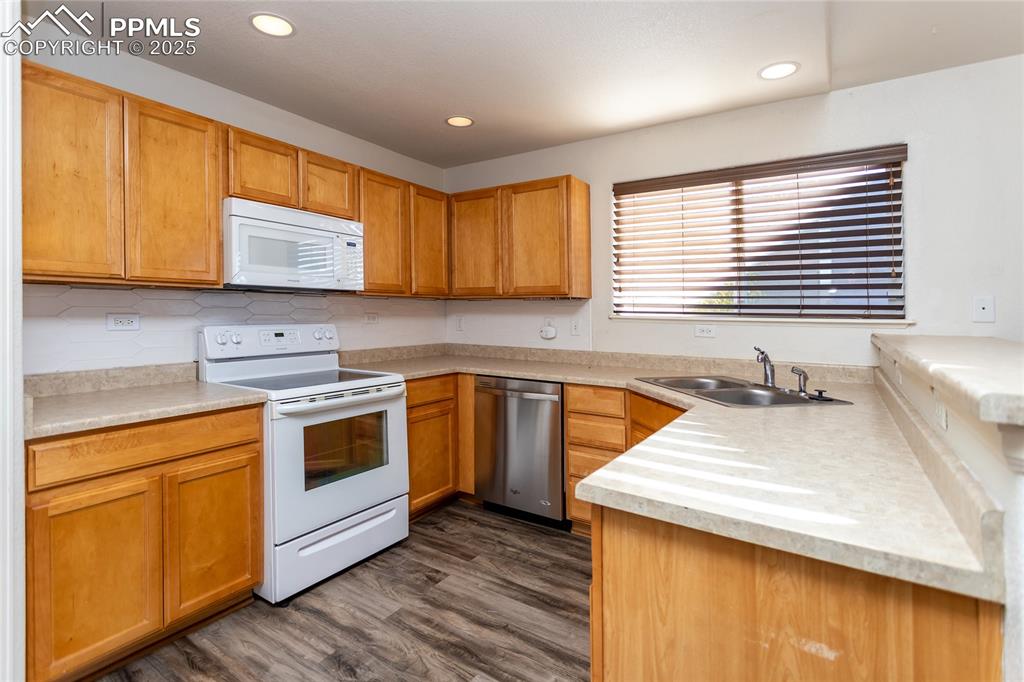 6806 Red Cardinal Loop Colorado Springs, CO 80908 - Photo 7 of 32 a kitchen with a stove a sink and a microwave