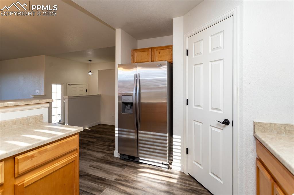 6806 Red Cardinal Loop Colorado Springs, CO 80908 - Photo 9 of 32 a kitchen with stainless steel appliances granite countertop a refrigerator and a sink