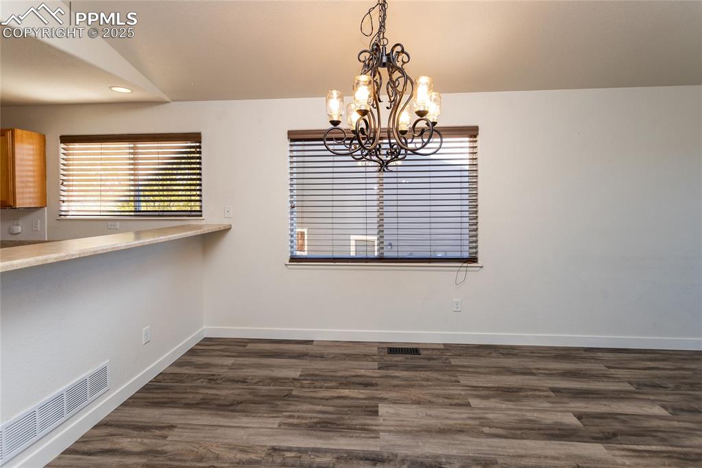 6806 Red Cardinal Loop Colorado Springs, CO 80908 - Photo 10 of 32 a view of a room with a window and wooden floor