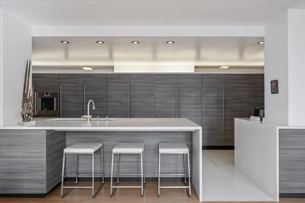 a large white kitchen with a large window