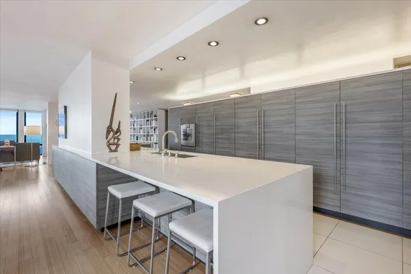 a kitchen with a stove and white cabinets