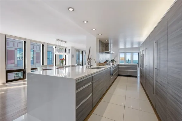 a kitchen with stainless steel appliances a sink a table and chairs