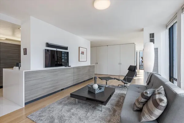 a spacious bedroom with a bed and a flat screen tv