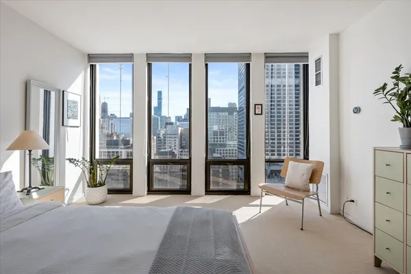 a view of a livingroom with workspace and a window