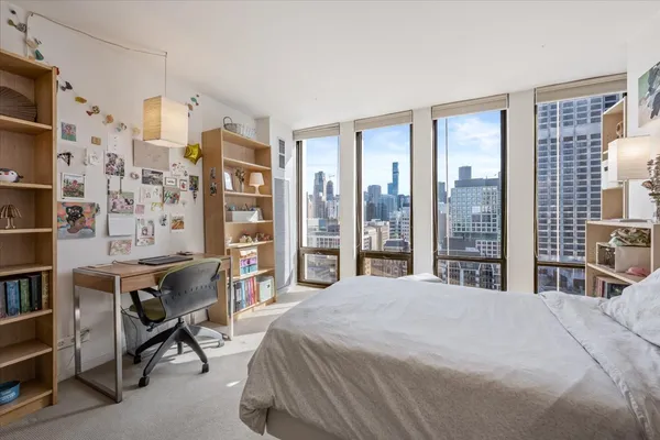 a bedroom with a bed and a lamp on table