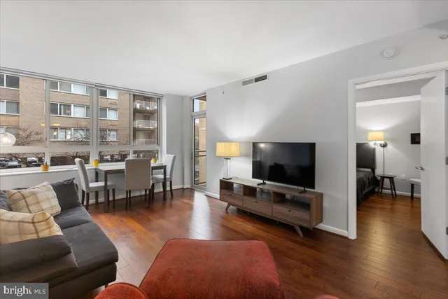 a dining room with furniture window and wooden floor
