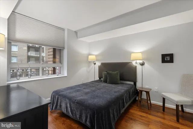 a bedroom with a bed and a lamp