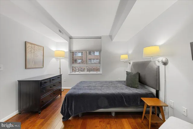 a bathroom with a toilet a sink a mirror and vanity