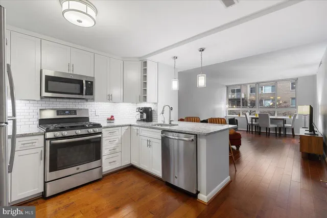 a kitchen with a sink a stove a refrigerator and a refrigerator