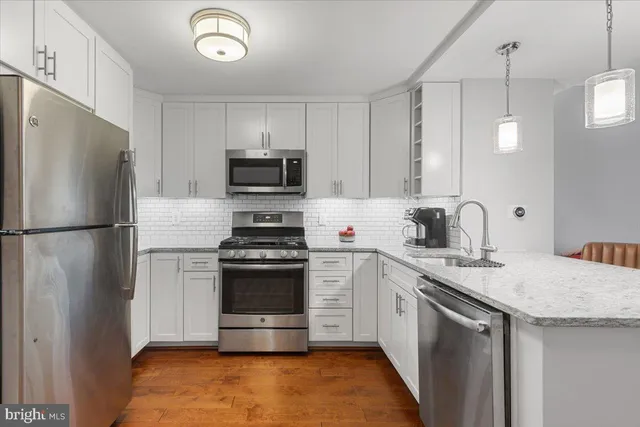 a kitchen with a refrigerator stove and microwave