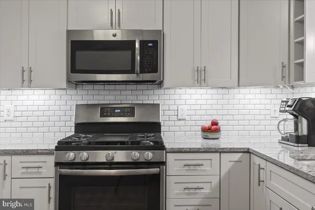 a kitchen with granite countertop a sink and a wooden cabinets