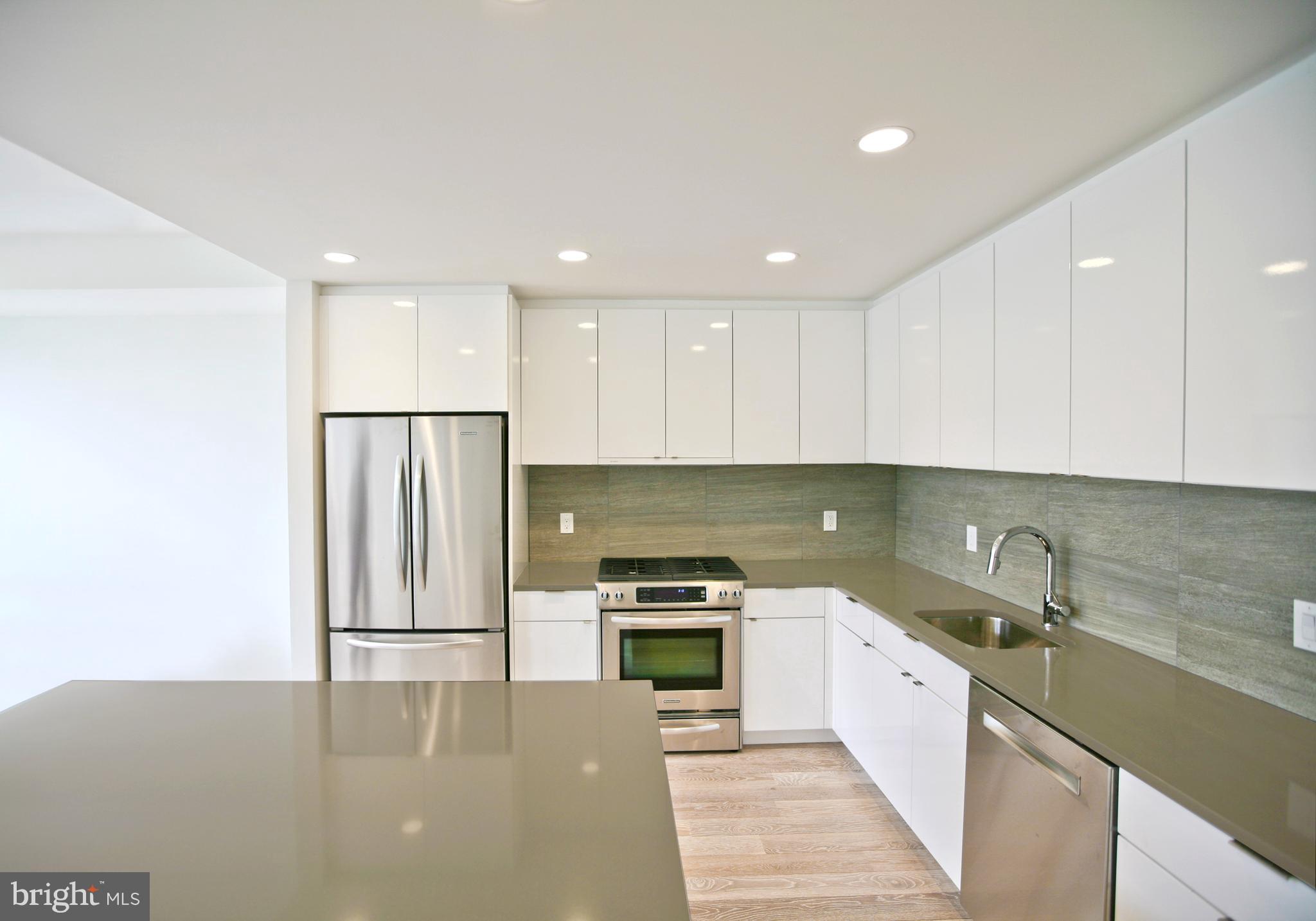 1234 10th Street Northwest, Unit A Washington, DC 20001 - Photo 6 of 17 a kitchen with granite countertop a refrigerator and a sink