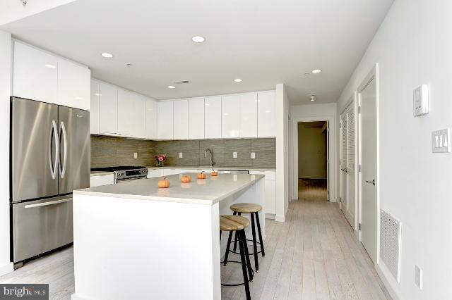 1234 10th Street Northwest, Unit A Washington, DC 20001 - Photo 7 of 17 a kitchen with refrigerator a sink and a counter top space