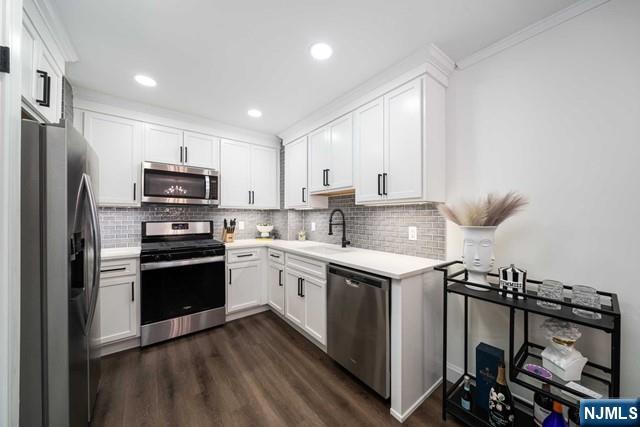 141 Park Avenue, Unit 8A East Rutherford, NJ 07073 - Photo 6 of 22 a kitchen with stainless steel appliances a stove a sink and a refrigerator