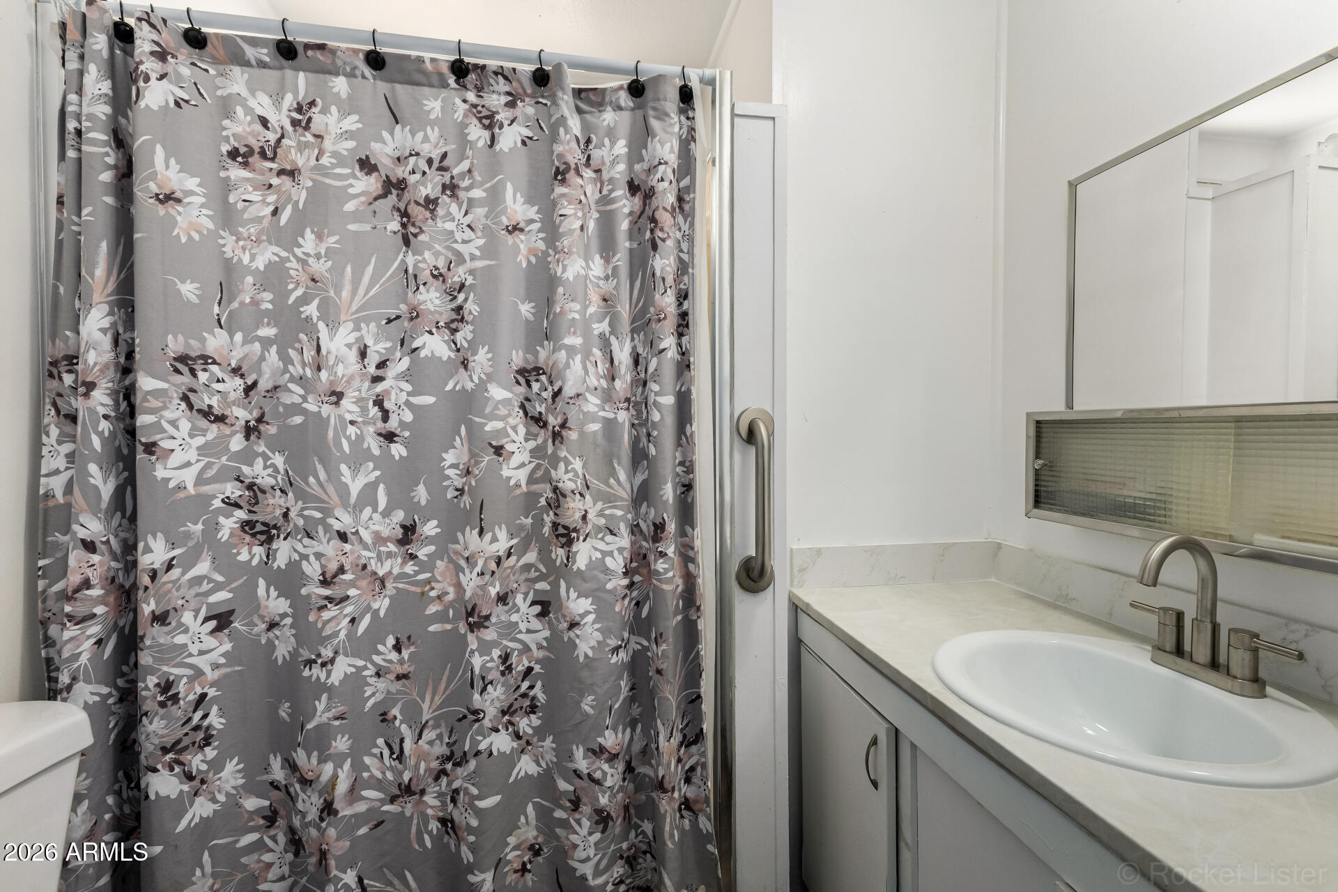 5201 West Camelback Road, Unit G264 Phoenix, AZ 85031 - Photo 9 of 16 a bathroom with a sink and a mirror