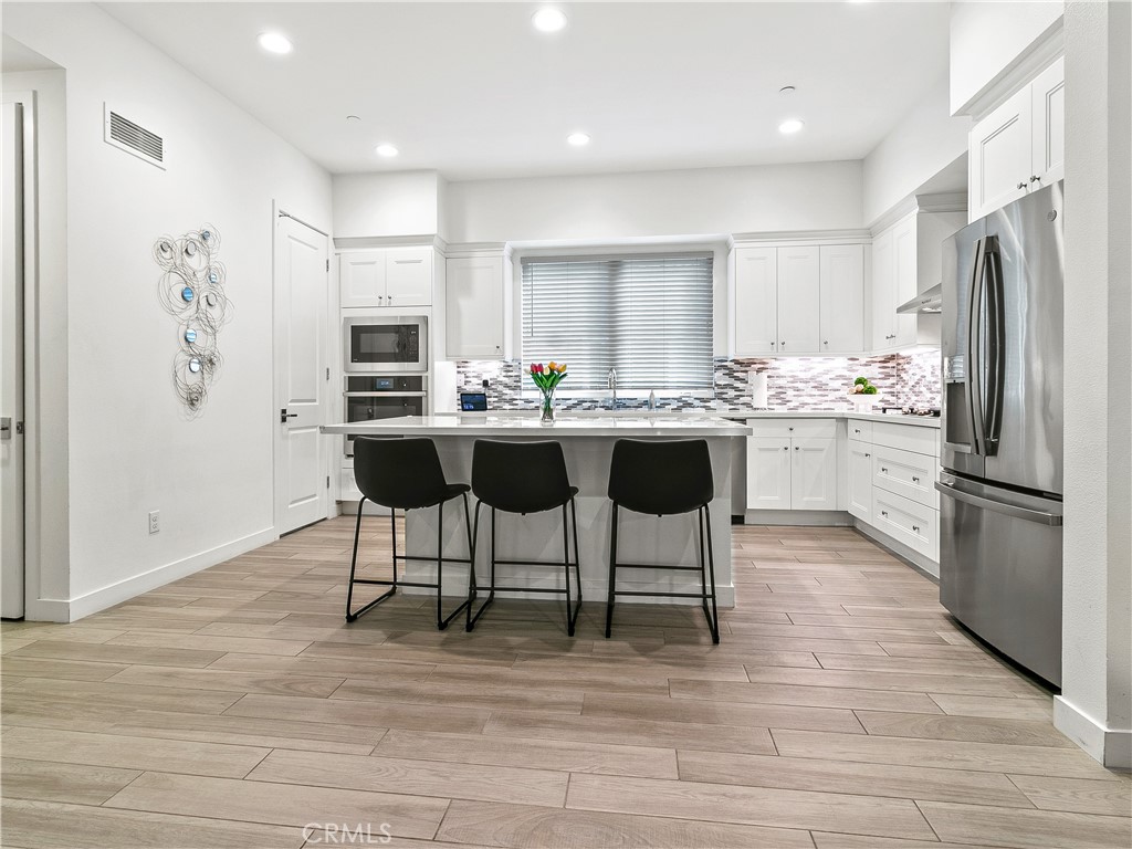 985 Doheny Way Dana Point, CA 92629 - Photo 23 of 53 a kitchen with stainless steel appliances kitchen island granite countertop a refrigerator and a stove top oven