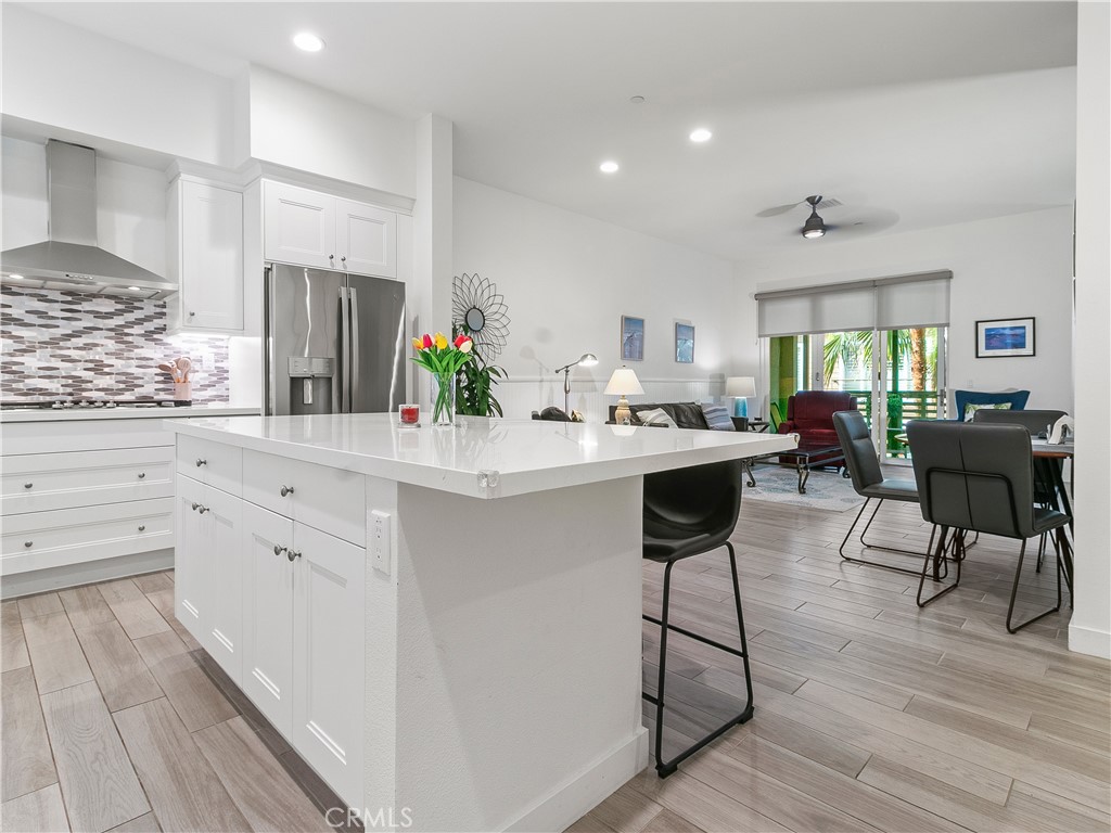 985 Doheny Way Dana Point, CA 92629 - Photo 25 of 53 a kitchen with white cabinets and chairs