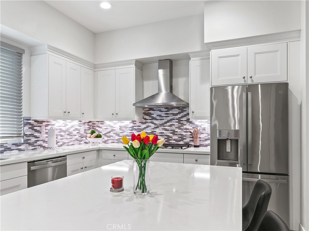 985 Doheny Way Dana Point, CA 92629 - Photo 26 of 53 a kitchen with stainless steel appliances a refrigerator a sink a stove and white cabinets