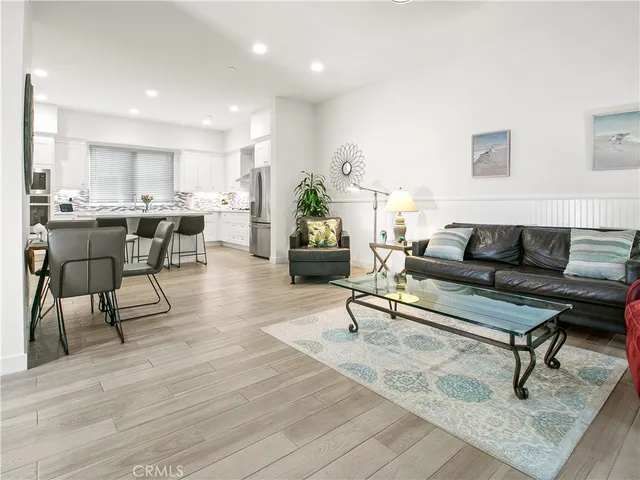 a view of a hallway with wooden floor and a potted plant