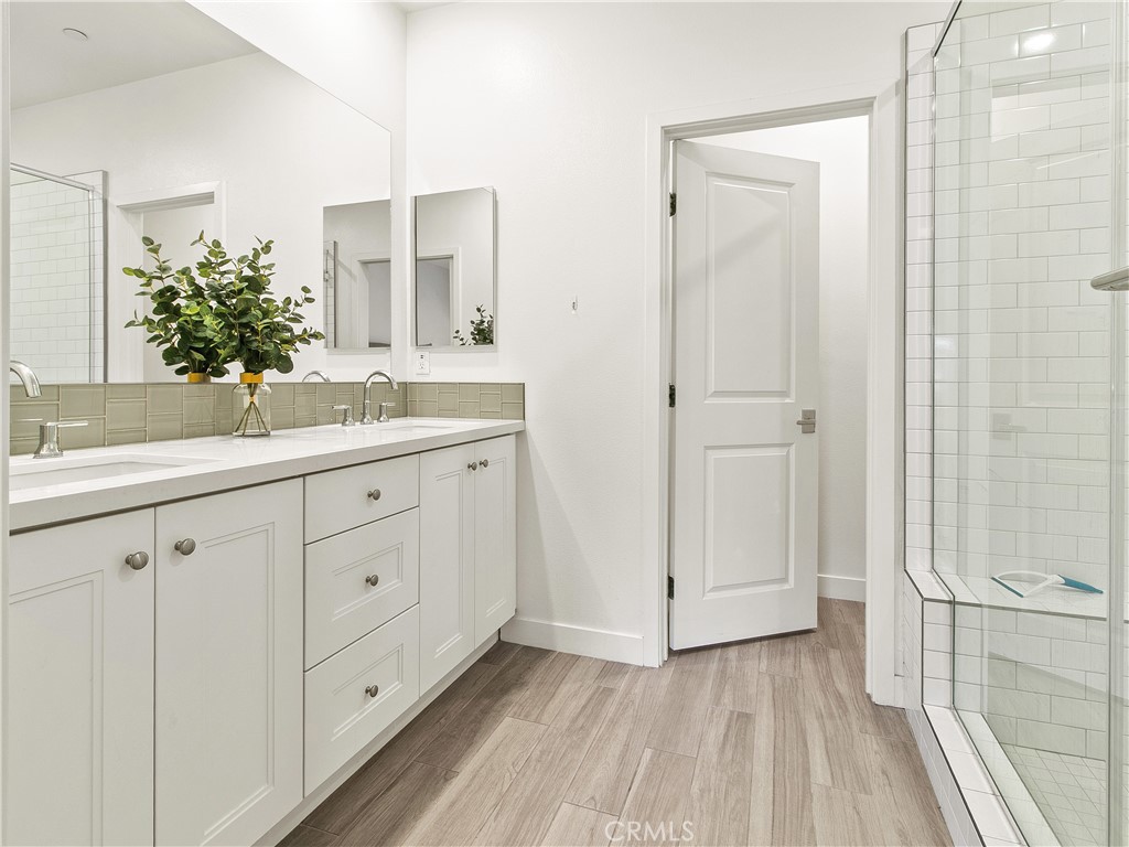 985 Doheny Way Dana Point, CA 92629 - Photo 44 of 53 a spacious bathroom with a double vanity sink a mirror and a shower