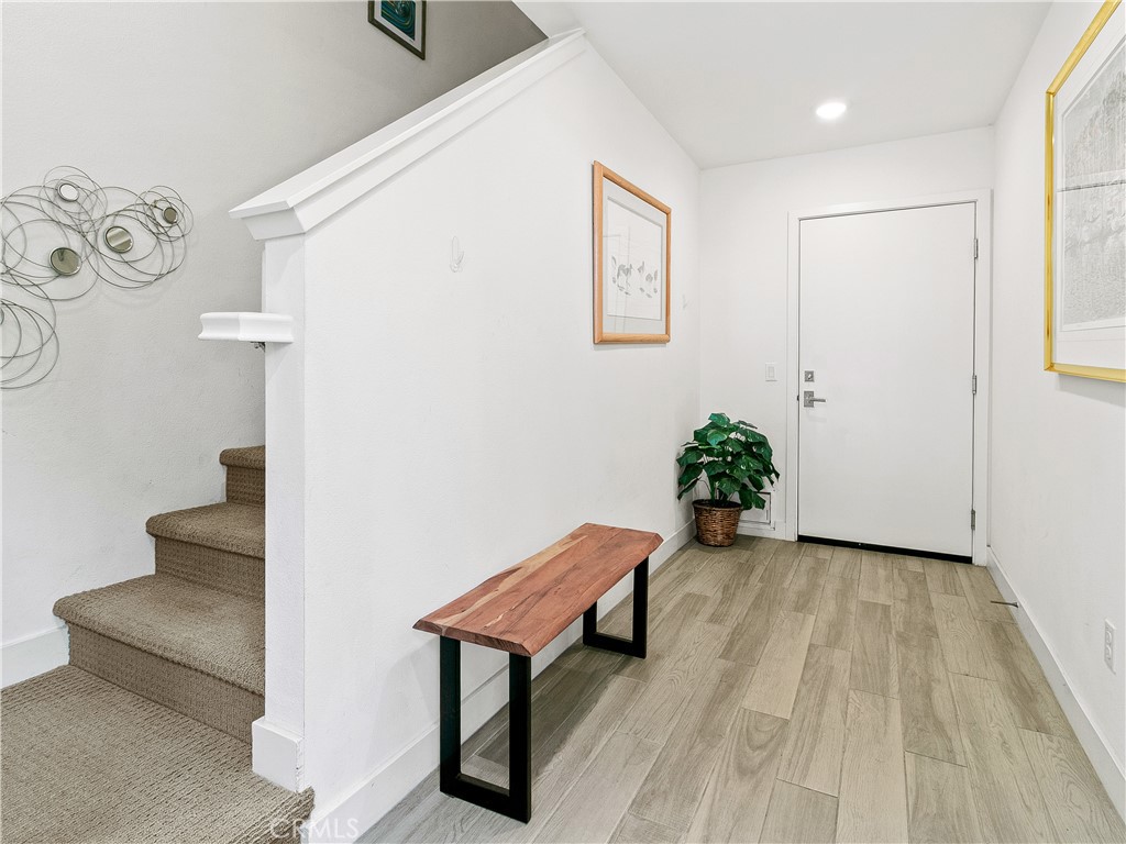 985 Doheny Way Dana Point, CA 92629 - Photo 53 of 53 a view of a hallway with wooden floor and a potted plant