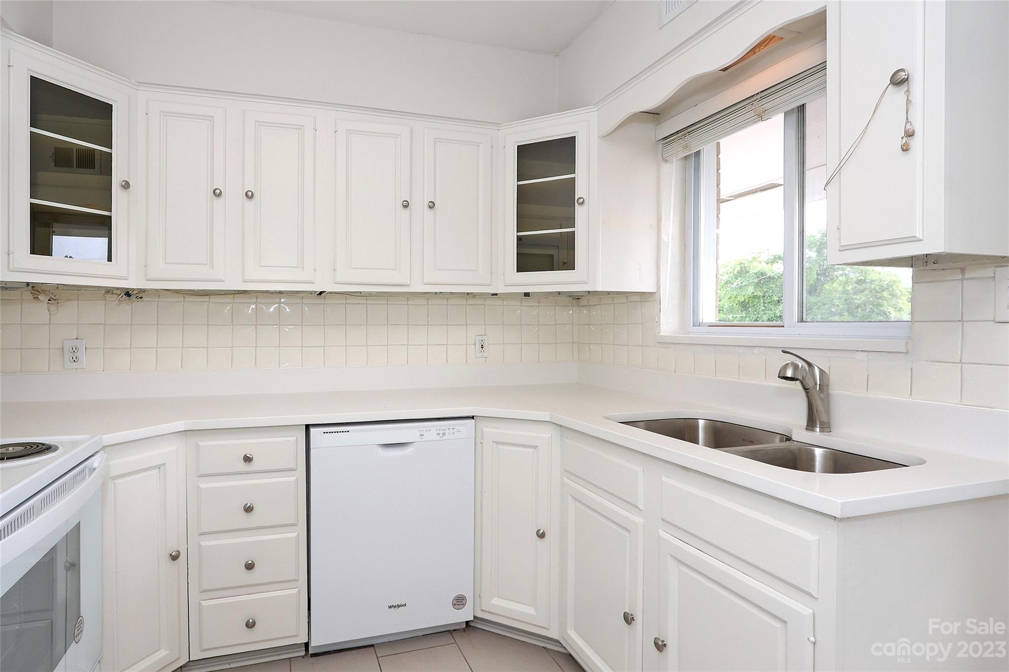 3010 Crosby Road, Unit 220 Charlotte, NC 28211 - Photo 15 of 39 a kitchen with white cabinets and a sink