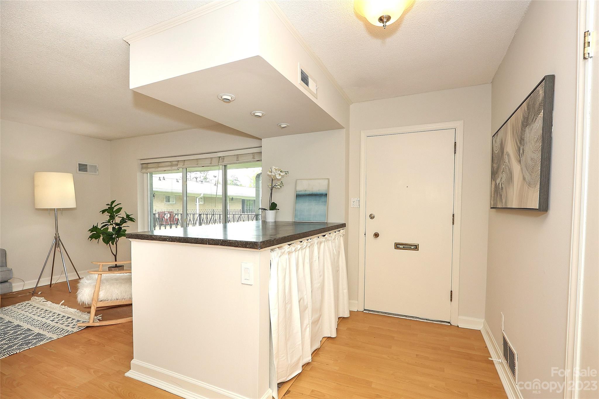 3010 Crosby Road, Unit 220 Charlotte, NC 28211 - Photo 5 of 39 a view of a hallway with wooden floor and a living room