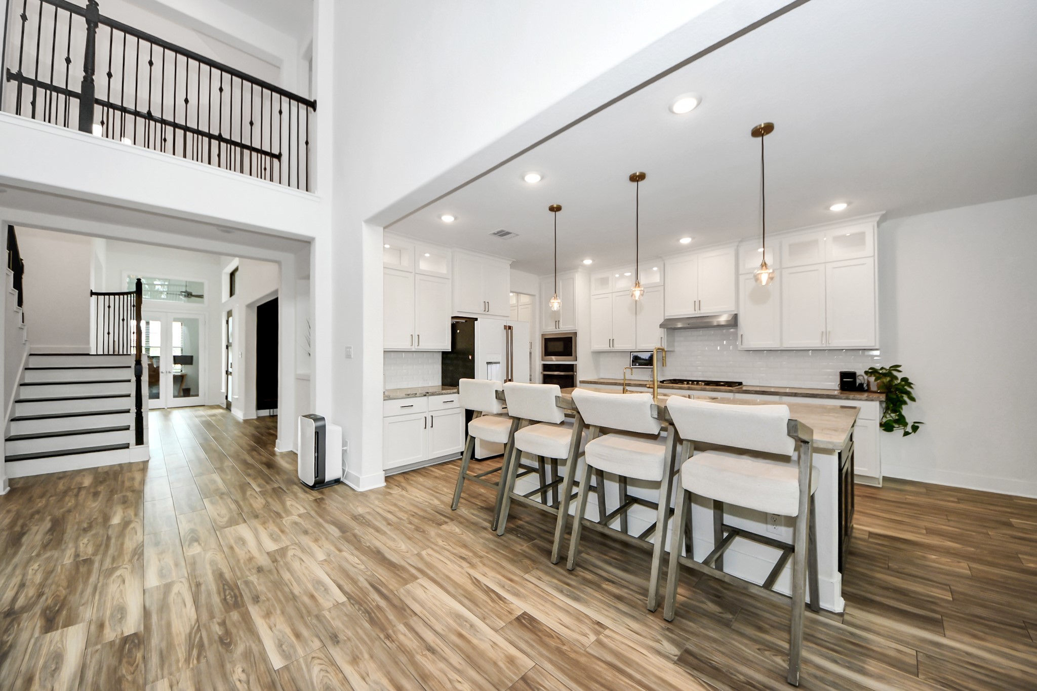 17355 Camillia Trail Conroe, TX 77302 - Photo 6 of 34 a open kitchen with stainless steel appliances granite countertop a dining table chairs and a wooden floor