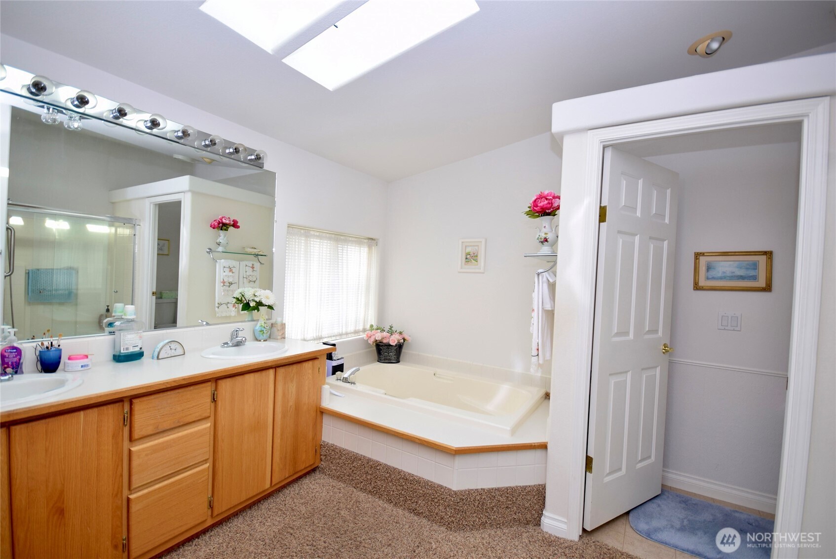 891 North Portside Way Sequim, WA 98382 - Photo 12 of 18 a spacious bathroom with a tub sink mirror and vanity