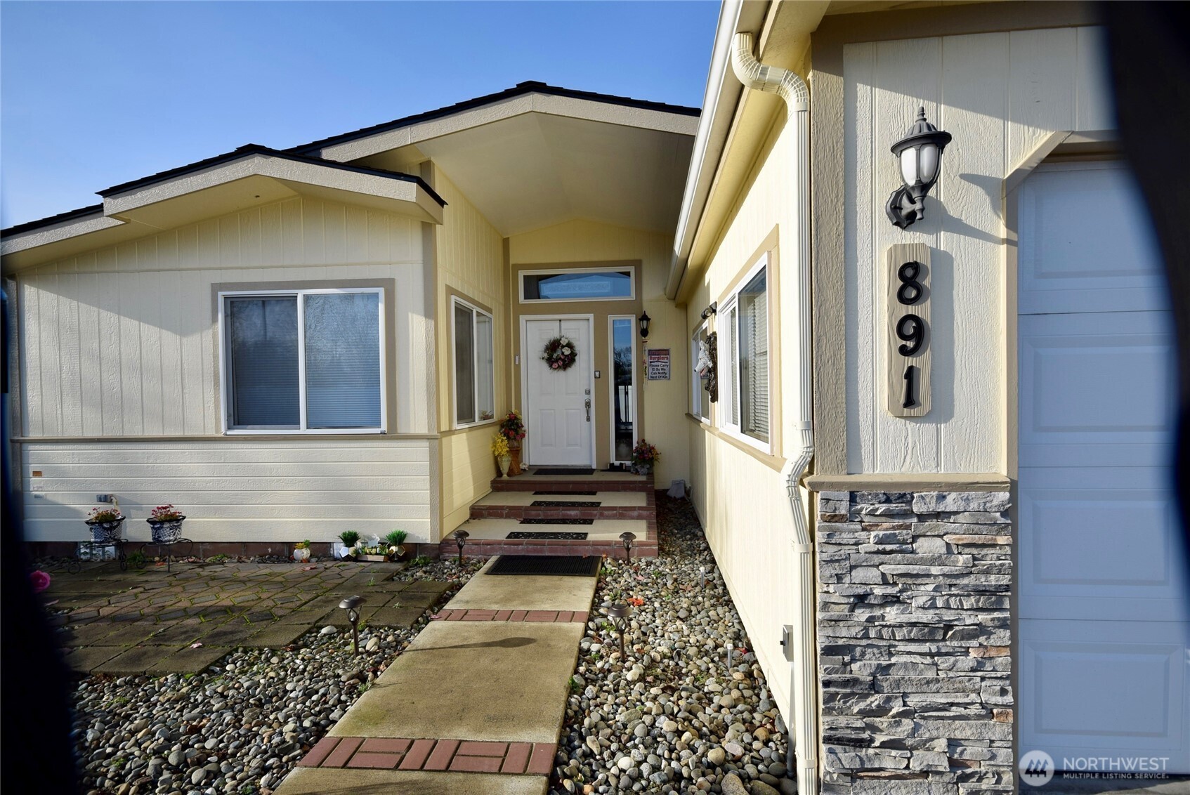 891 North Portside Way Sequim, WA 98382 - Photo 2 of 18 a front view of a house with a yard