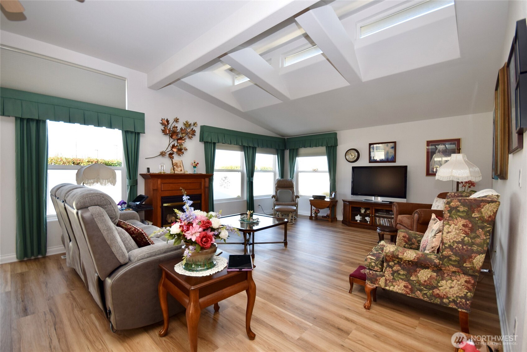 891 North Portside Way Sequim, WA 98382 - Photo 5 of 18 a living room with furniture flat screen tv and a fireplace