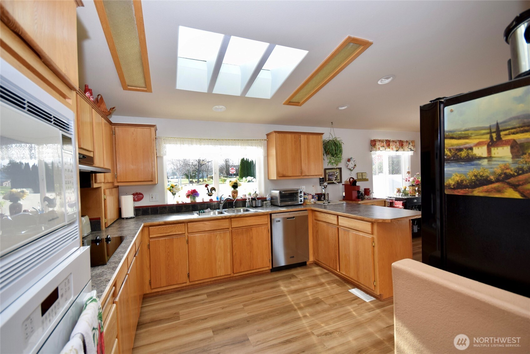 891 North Portside Way Sequim, WA 98382 - Photo 9 of 18 a kitchen with stainless steel appliances granite countertop a sink dishwasher stove and refrigerator
