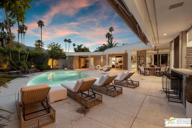 a view of a couches and dinning table and chairs in patio