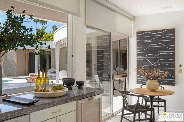 a vase of flowers sitting on a floor